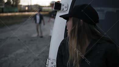 The scene of the scared girl runs away from the zombie, hiding behind the white van. Two creepy zombies coming for her