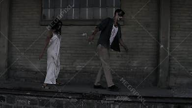 Halloween horror concept. Picture of creepy male and female ghost or zombie walking with wounded face. An old abandoned