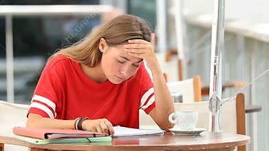 Frustrated student studying in a coffee shop