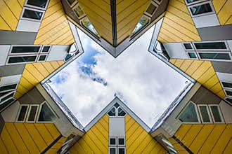 Simmetry Gleam between Yellow Cubic houses and apartments in Rotterdam. The Netherlands