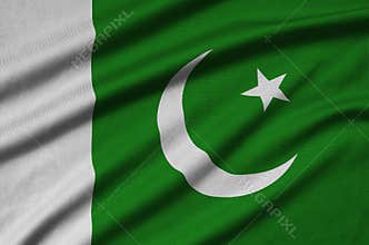 Pakistan flag is depicted on a sports cloth fabric with many folds. Sport team banner