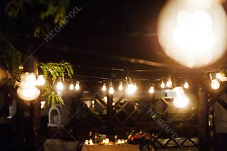 Light bulb decor in outdoor party. Wedding