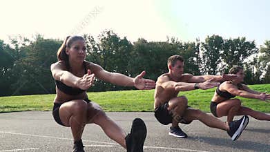 Beautiful two girls and one boy doing pistol squats