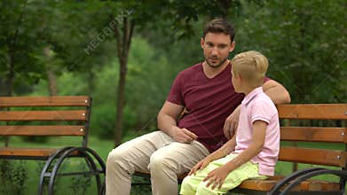 Conversation between father and son in park, loving dad giving advices to kid