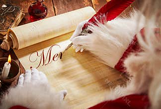 Santa Claus handwriting a Christmas greeting