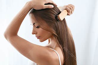 Beauty Hair Care. Beautiful Woman Brushing Long Healthy Hair