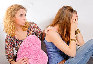 Young teenage girl comforting her friend