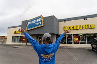 AUGUST 12 2018 - FAIRBANKS ALASKA: Female customer stands outside a Blockbuster Video rental store with arms out