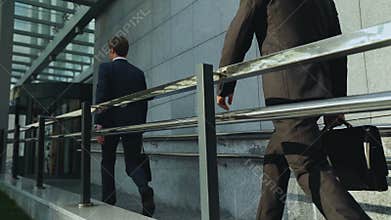 Young entrepreneurs entering office building, business people, careerists