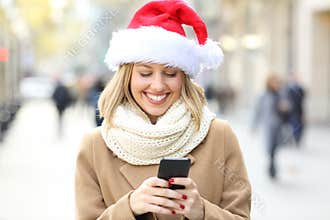 Woman reading phone text on christmas