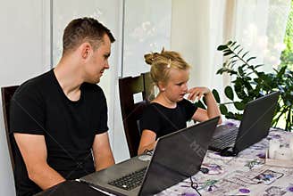 Brother and sister together with laptop computers