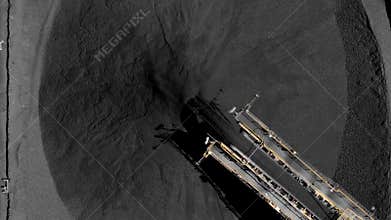 Aerial footage of coal stockpiles and coal conveyor belt crane