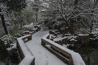 Humble Administrator`s Garden bridge in snow, ancient suzhou, china