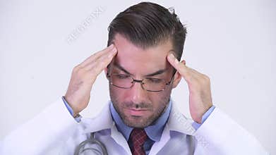 Young stressed Hispanic man doctor having headache