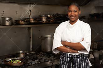 Female Chef Standing Next To Cooker