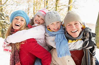 Family Having Fun Snowy Woodland