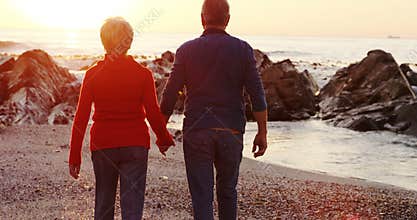Senior couple walking on beach 4k