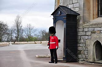 A guard wearing traditional bearskin standing to attention, UK