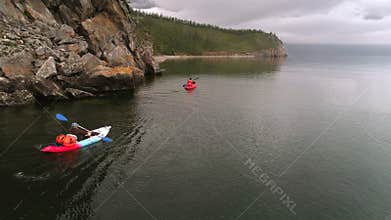 Two canoes on the lake. Tourists canoeing on the Bay. Aerial drone shot.