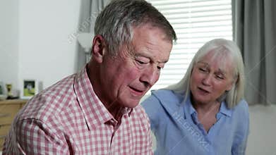 Woman Comforting Man With Depression At Home