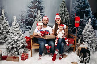 Happy family with kids at Christmas time.
