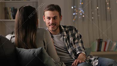 Couple talking on a couch in the night