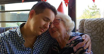 Mother and son embracing each other in living room 4k