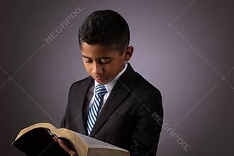 Little Hispanic Boy Reading the Holy Scriptures, The Bible, The Word of God