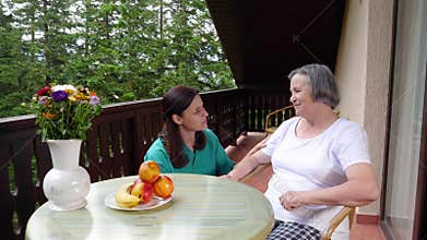 Care worker spending time with old lady in her home