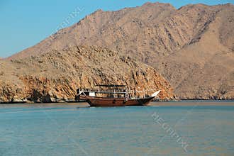Ship near coast of Musandam peninsula in Oman