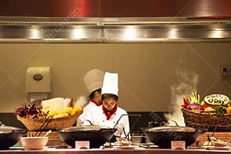 Chef and assistant Chefs cooking and prepared buffet food at restaurant in night time in Bangkok, Thailand