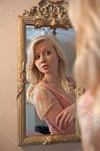 Blond Woman Gazing at Self in Mirror