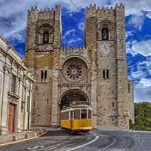 Yellow Tram and Lisbon Cathedral of St. Mary Major Se de Lisboa in Lisbon, Portugal