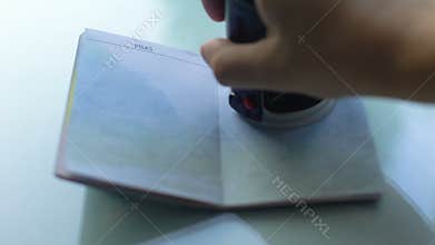 Refugee visa granted, customs officer hand stamping seal in passport, travel