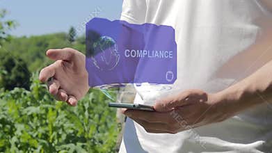 Man shows concept hologram Compliance on his phone