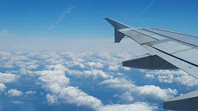 Wing airplane flying above clouds