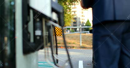 Businessman charging electric car at charging station 4k