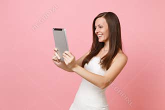 Smiling bride woman in wedding dress working doing taking selfie shot on tablet computer, making video call on