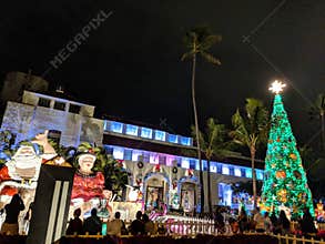 People look at Mr. and Mrs. Claus sit on top waterfall and Christmas Tree