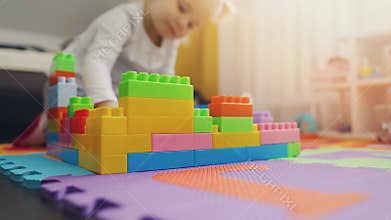 Child playing with building blocks on the floor