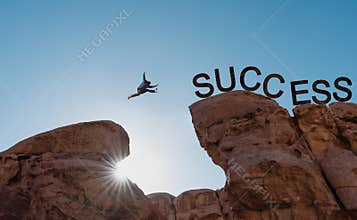Business success, challenge, achievement and leadership concept. Silhouette a man jumping over precipice to success