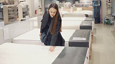 Customer woman buying new furniture - sofa or couch in a store