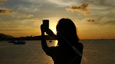 Young woman taking selfie against beautiful sunset during sea cruise. Slow Motion. Thailand. 1920x1080