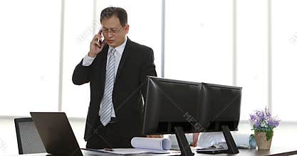 Asian businessman talking to cellphone.