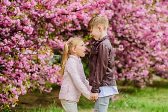 Love is in the air. Tender love feelings. Little girl and boy. Romantic date in park. Spring time to fall in love. Kids