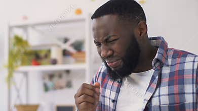 Shocked african american man burn tongue with hot drink, actively breathing