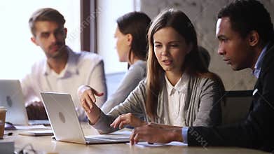 Young caucasian female worker mentor helping male african american intern