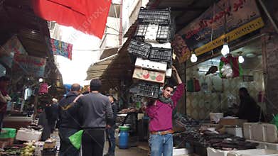 Amman, Jordan - 2019-04-18 - man carries huge stack of empty cartons in market
