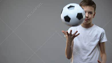 Actve teen boy playing with soccer ball, young champion, hobby and lifestyle