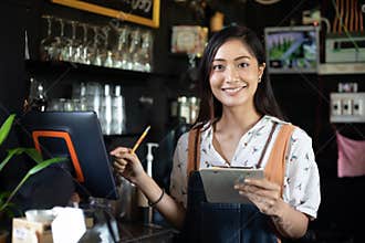 Asian women Barista smiling and using coffee machine in coffee shop counter - Working woman small business owner food and drink